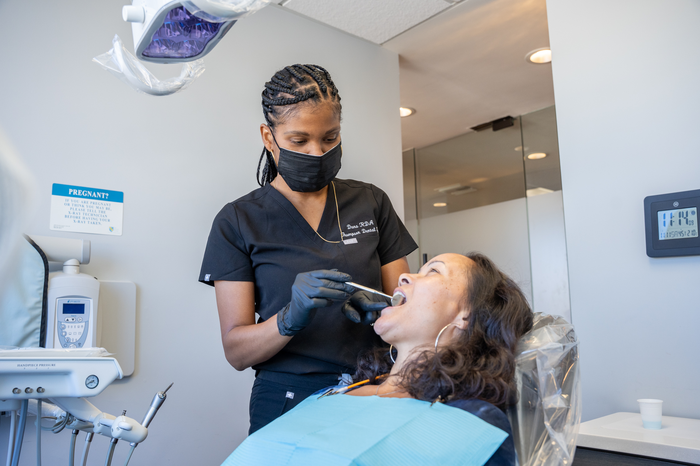 Dana L. of Derrick Thompson DDS INC is examining a patient's mouth - Dentist Los Angeles Dana L. of Derrick Thompson DDS INC is examining a patient's mouth - Dentist Los Angeles