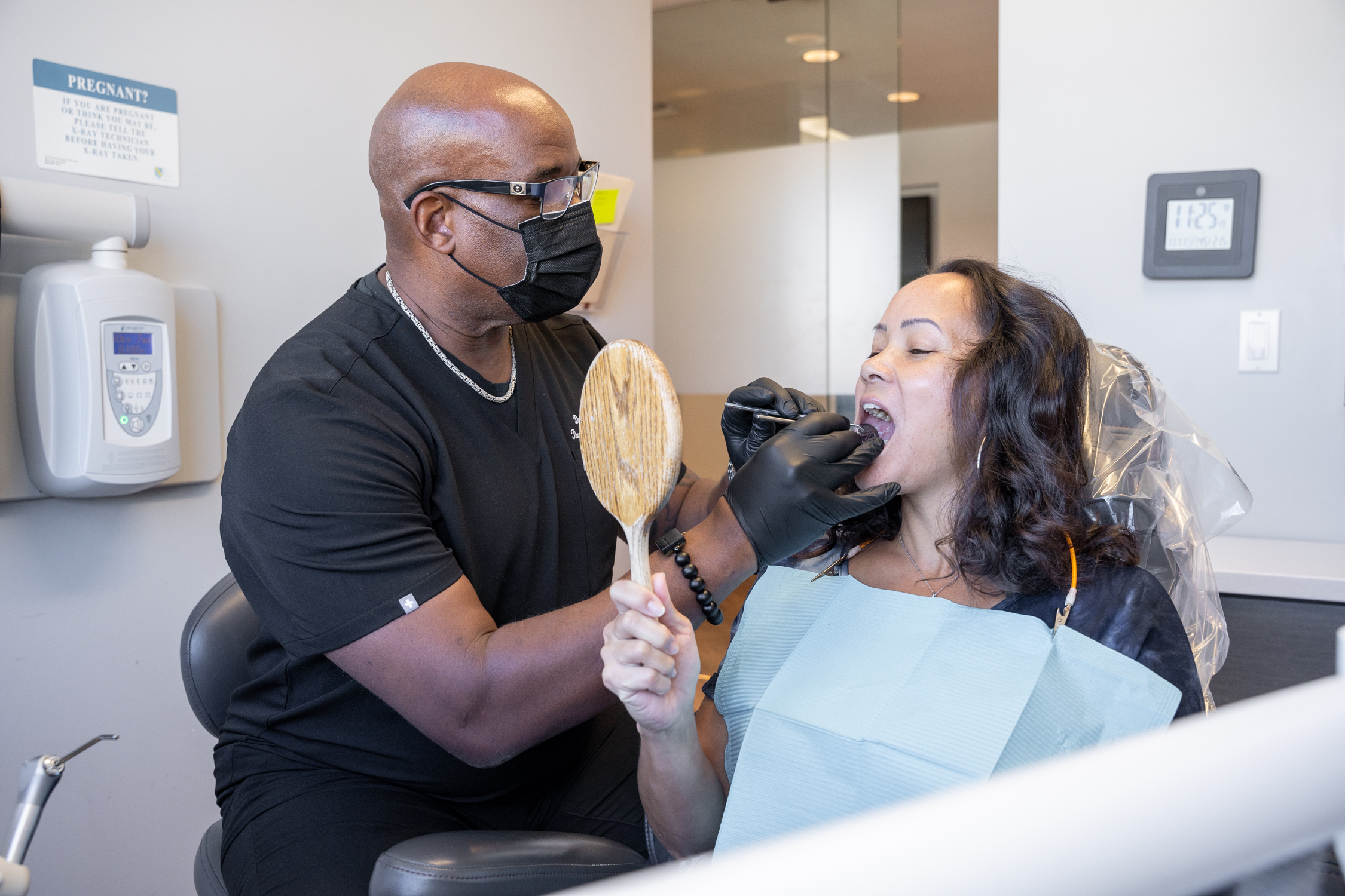 Dr. Thompson examining a patient - Affordable Dental Implants In Los Angeles, CA