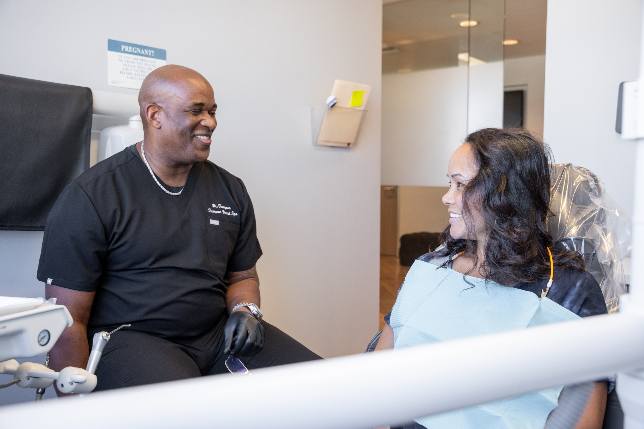 Dr. Derrick L. Thompson is having a conversion with a lady patient discussing treatment options - Dentist Los Angeles Dr. Derrick L. Thompson is having a conversion with a lady patient discussing treatment options - Dentist Los Angeles
