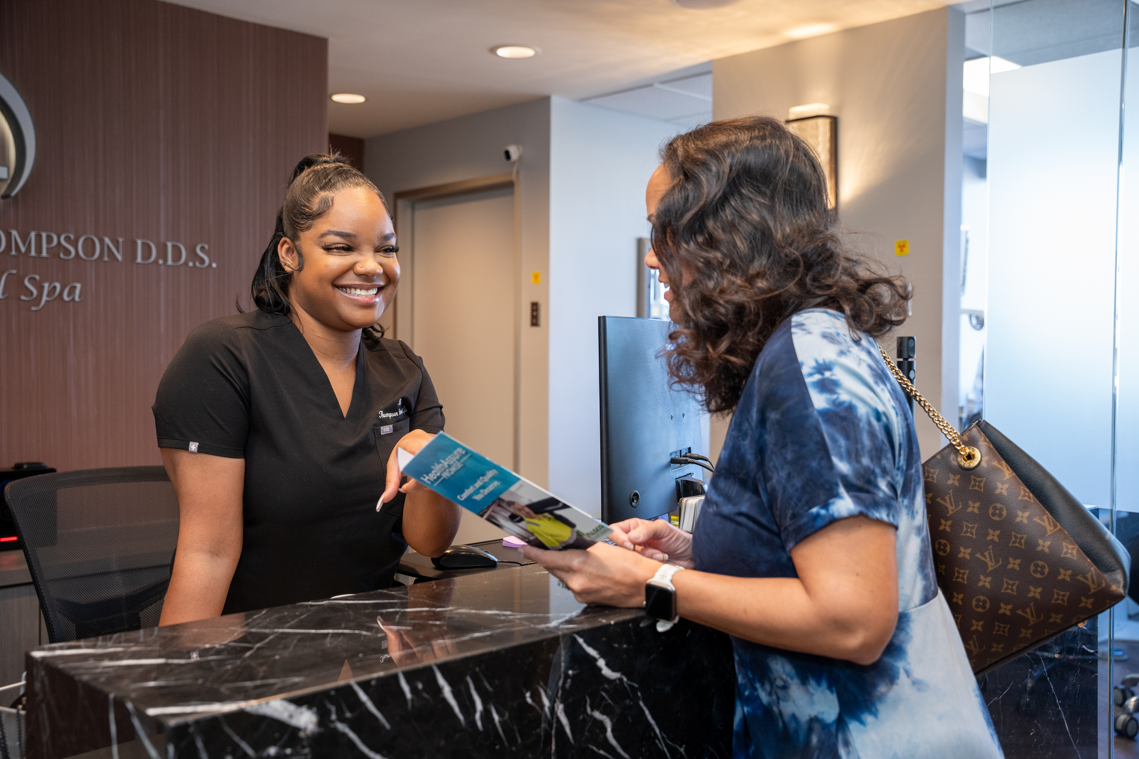 Nia T., the Administrative Assistant of Derrick Thompson DDS INC is having a good conversation entertaining with a potential customer - Dentist Los Angeles Nia T., the Administrative Assistant of Derrick Thompson DDS INC is having a good conversation entertaining with a potential customer - Dentist Los Angeles